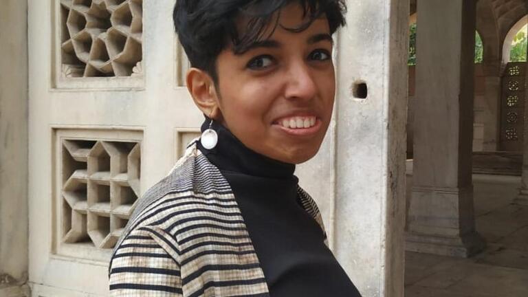 Photo of Priyanka D'Souza standing in front of a building 