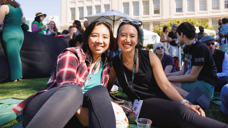 mother and daughter hanging out together on usf lawn during celebrate usf event