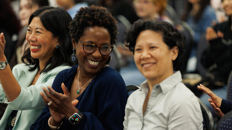 faculty members sitting in a crowd during the Critical Diversity Studies Forum event