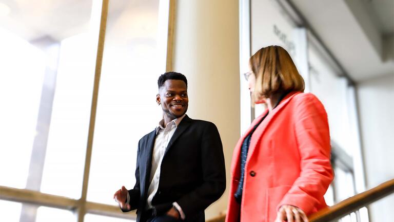 Student talking to a professor on the stairs