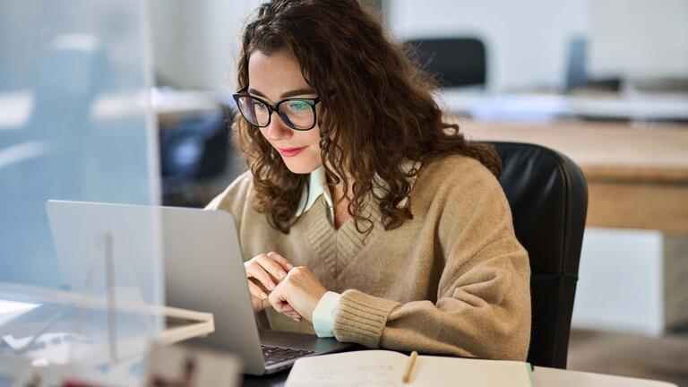Student watching webinar on laptop