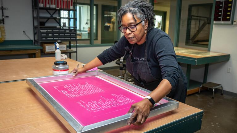 Cheryl Derricotte screen printing in her studio