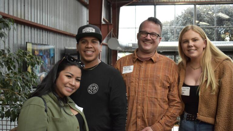 Group of four people smiling