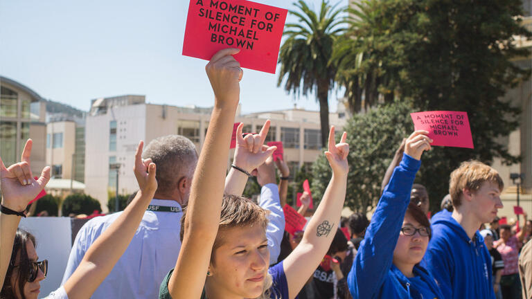 At USF Involvement Fair, hundreds observed a moment of silence to honor the death of Ferguson, Mo. teen Michael Brown.