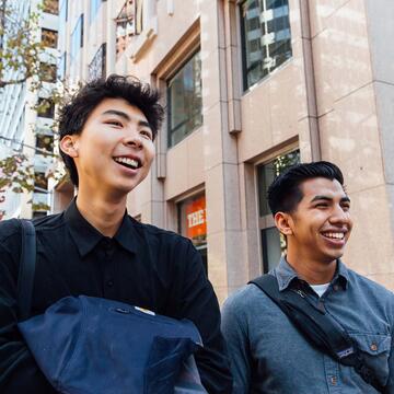 Students walk on a downtown street.