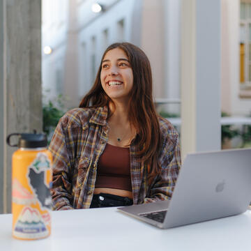 Student with a laptop studying.