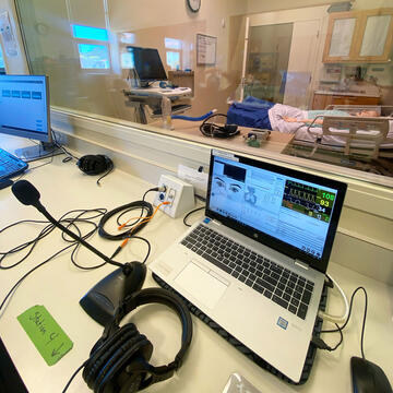 laptop and headphones behind glass in immersive learning spaces