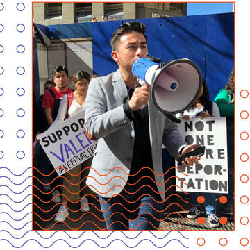 Edwin Carmona-Cruz speaking into a megaphone at a rally