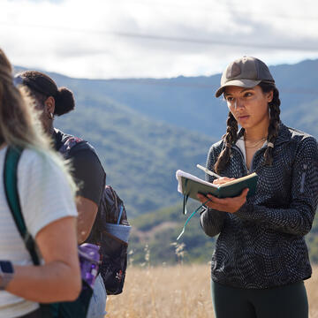 student taking notes while standing outside at Quicksilver County Park