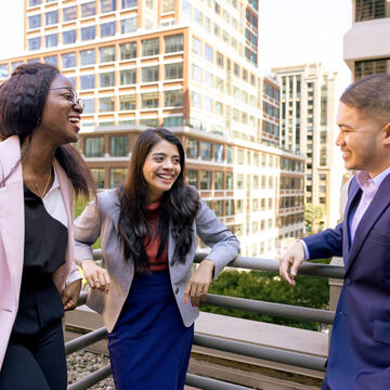 three students laughing together at downtown campus