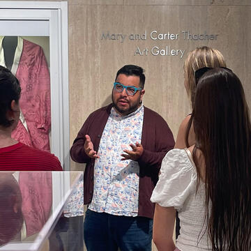 A person talking at the Thacher Art Gallery