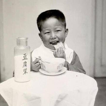 child sitting at table eating