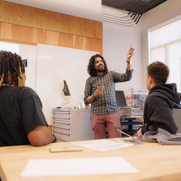 Professor talking to two students