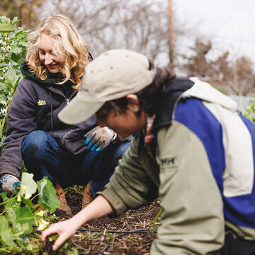 Two students working with plants.