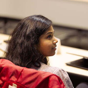 girl looks over her shoulder in class