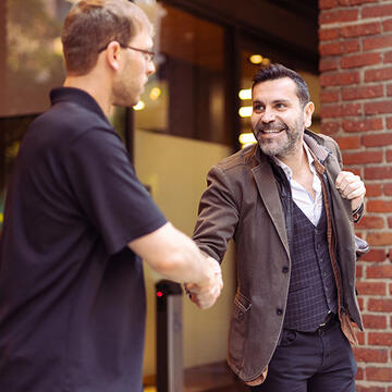 Grad student shaking hands with peer