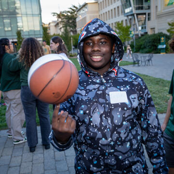 mentees spins basketball on fingertip