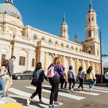 Group of students walking next to St. Ignatius