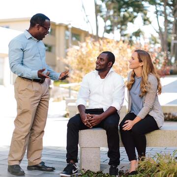 Three students talking to each other