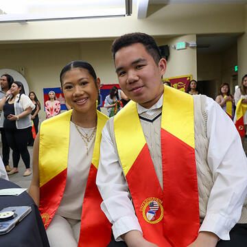 Two students dressed in cultural wear