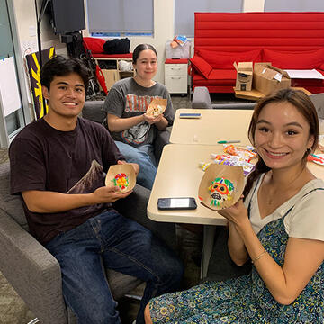 Three students making sugar skulls