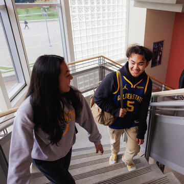 Student climbing stairs, following another student