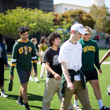 Group of students walking together on campus