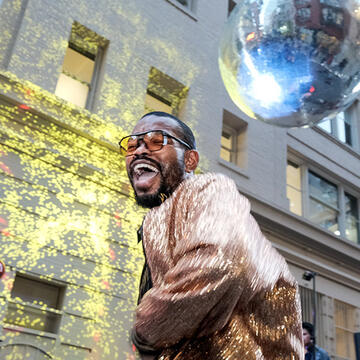 Person dancing under disco ball.