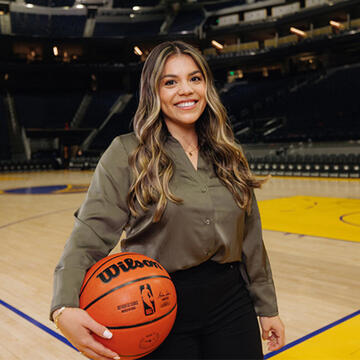 Sport management student holding a basketball