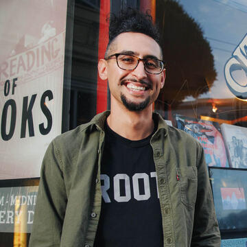 Smiling student in front of bookstore.