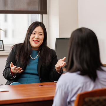 Professor chatting with student