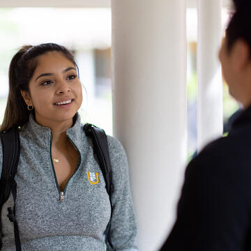 students talk outside at the OC campus