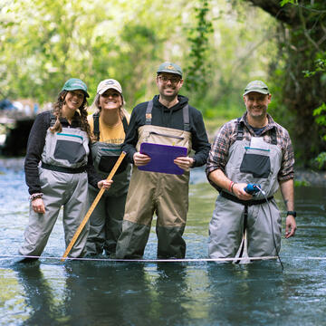 students standing in water wearing protective waterproof gear