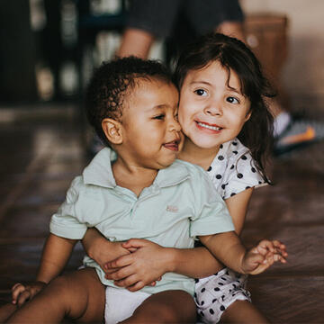 Toddler siblings hugging each other