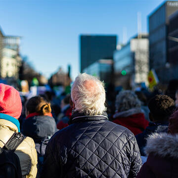 Back profile of elderly man in a crowd