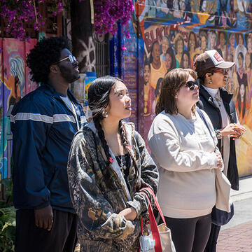 students look at murals in the mission