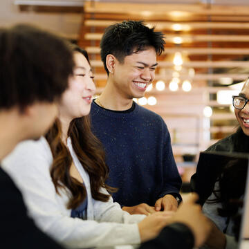 USF students sitting in cafeteria, chatting and smiling