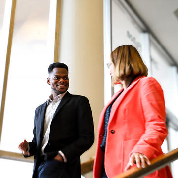 student and teacher walk down steps on usf campus