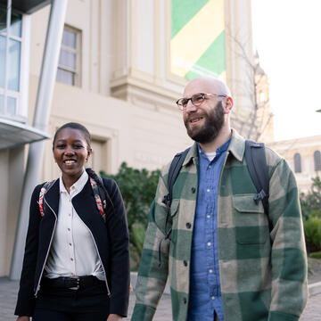 Two USF students walking in Gleeson Plaza