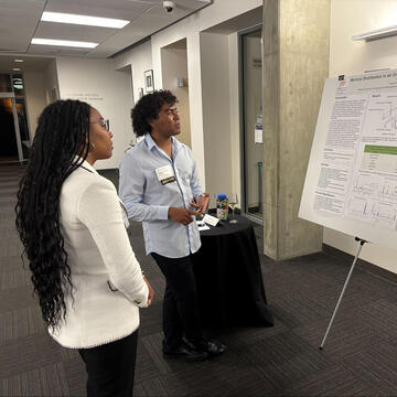 students present posters during event