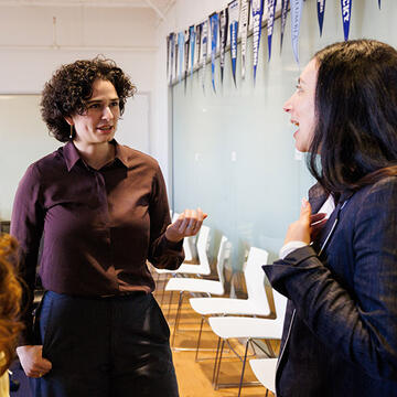 people speaking together inside a classroom