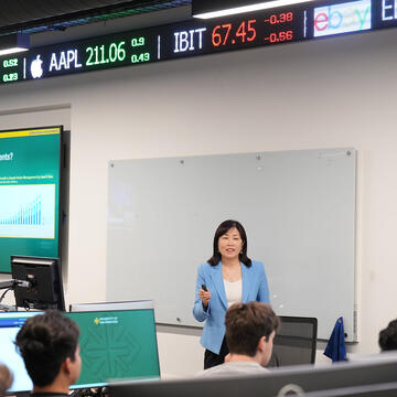 Professor teaching investment strategies in a university classroom