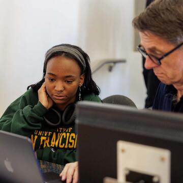 student and faculty working in the classroom together