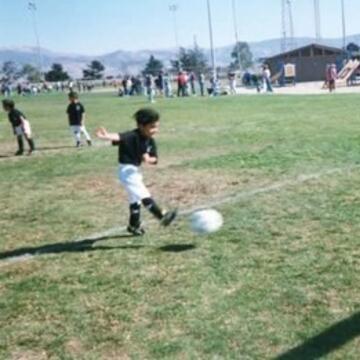 Young Jonathan de Anda kicking a soccer ball