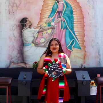 Ashley Perez holding a graduation cap