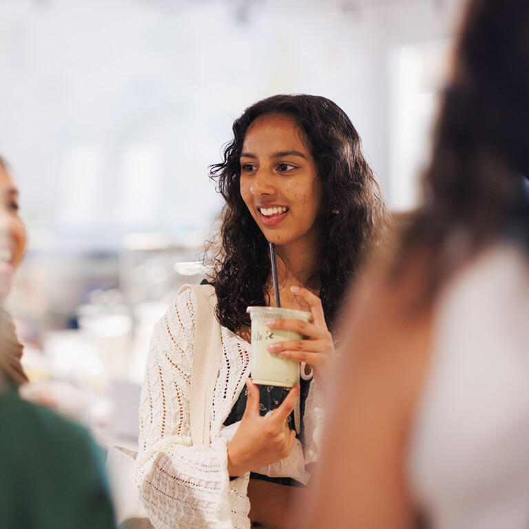 student holding drink