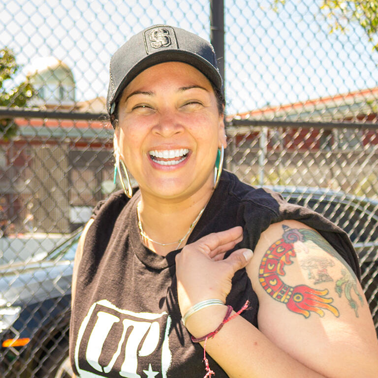 person with cap smiling outside United Playaz in San Francisco