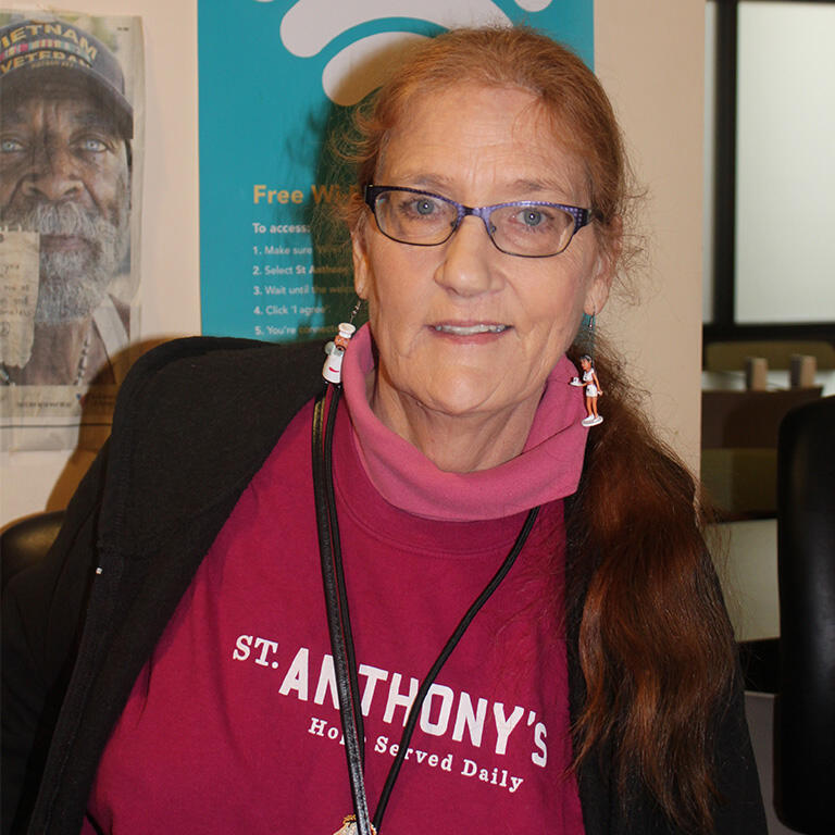 A woman wearing a pink St. Anthony's shirt