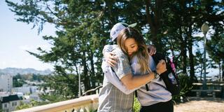 Student hugging parent