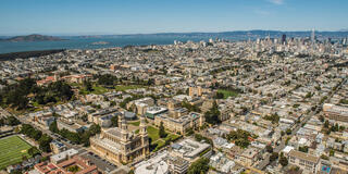 USF campus with San Francisco skyline in background.